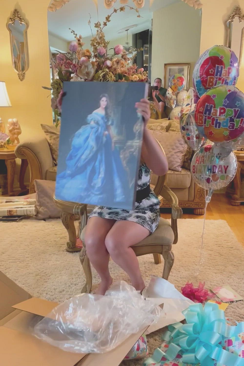 This may contain: a woman sitting in a chair with balloons and an image of a princess on it