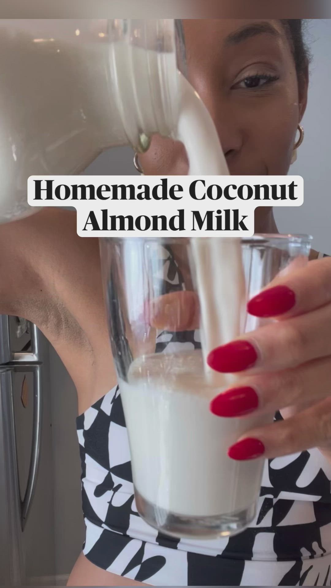 This may contain: a woman pouring milk into a glass with the words homemade coconut almond milk in it