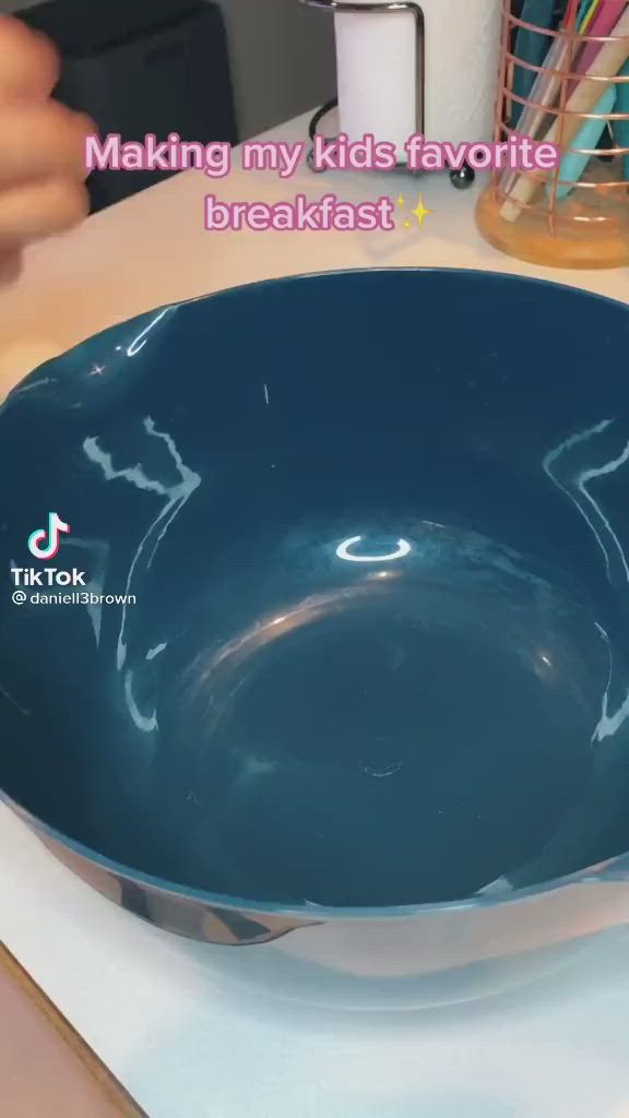 This may contain: a blue bowl sitting on top of a counter