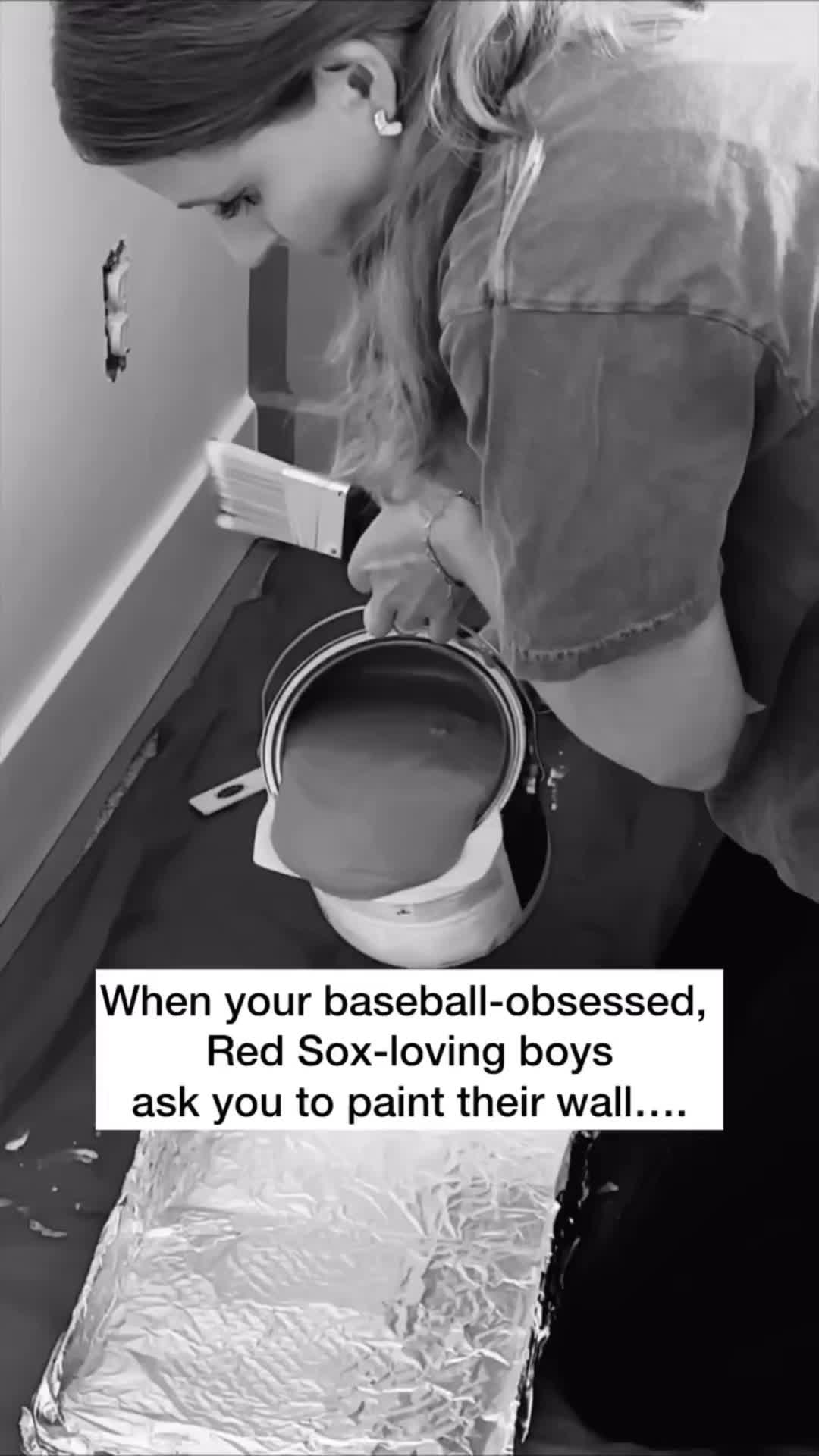 This may contain: a woman is painting a wall in black and white with text that reads, when your baseball - obesed, red sox - loving boys ask you to paint their wall