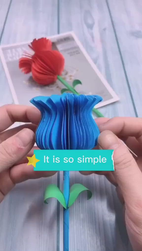 This may contain: someone is holding an origami flower with the words it is so simple in front of them