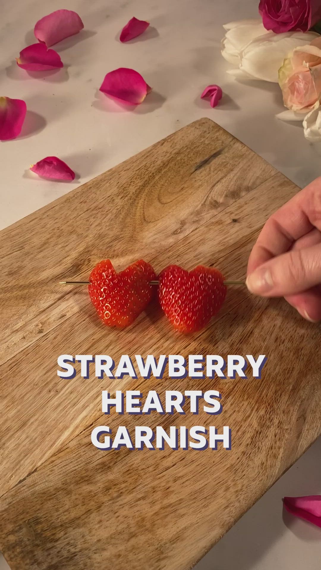 This may contain: two strawberries on a cutting board with the words strawberry hearts garnish