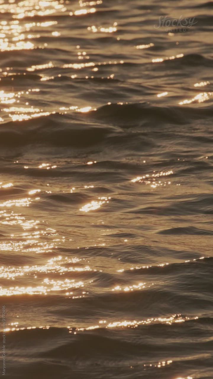 This may contain: the sun shines brightly on the water as it reflects off the ocean's surface