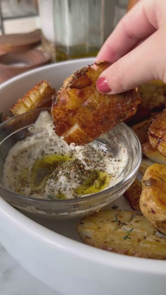 This may contain: a person dipping some food into a bowl