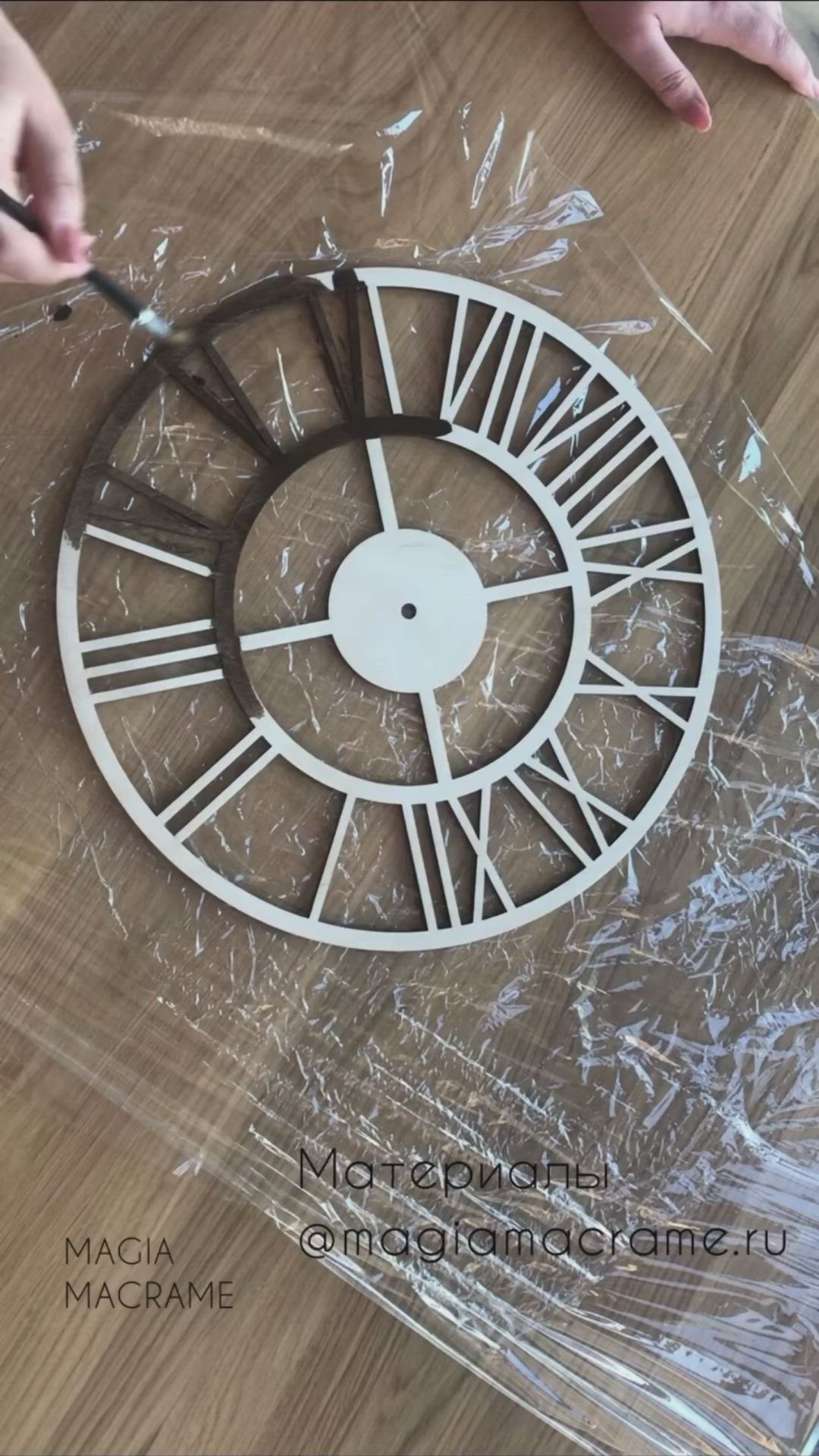 This may contain: someone is working on a piece of art with yarn and wood pieces in the shape of a clock