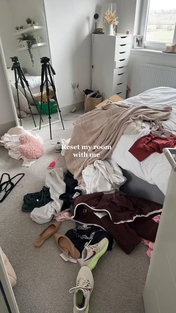 This may contain: a messy bedroom with clothes all over the floor