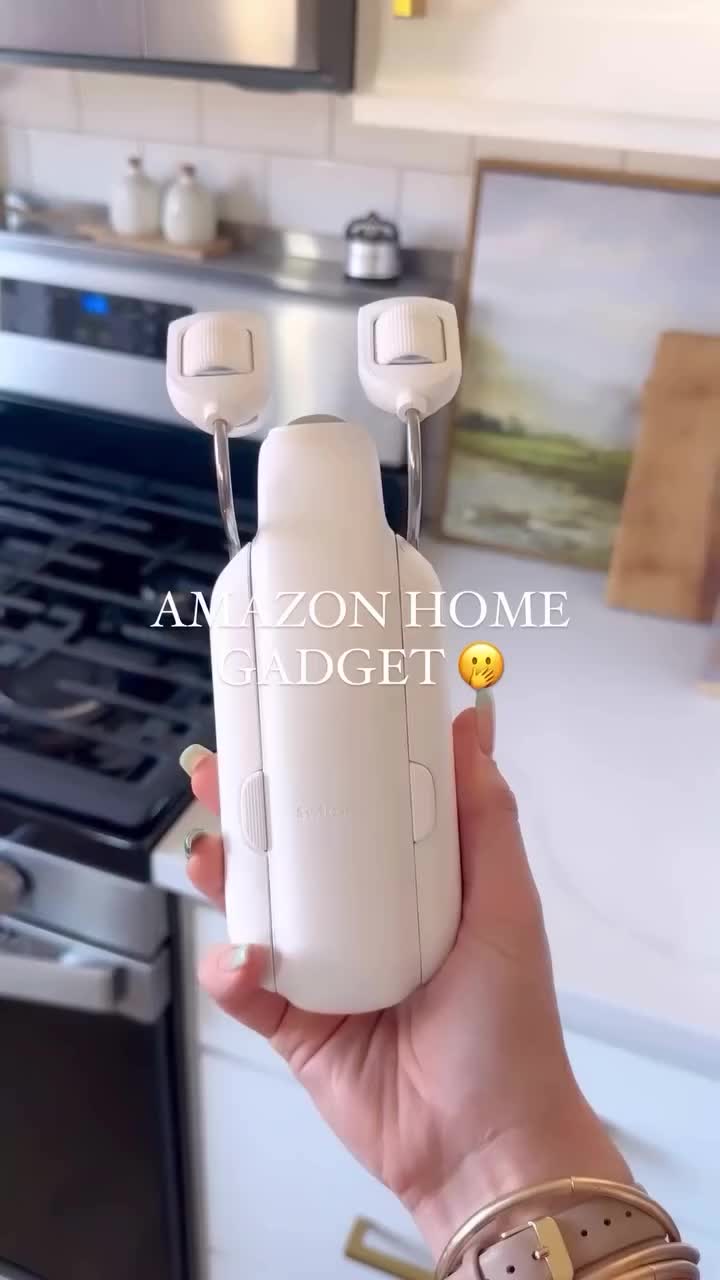 This may contain: a woman holding an object in her hand with the words amazon home on it's side