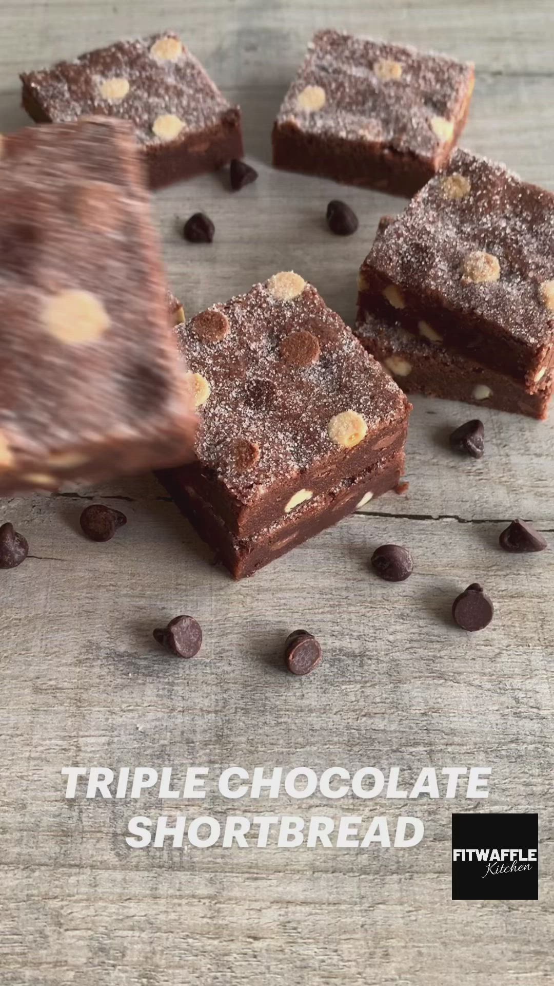 This may contain: chocolate fudge brownies are cut into squares and placed on a table with chocolate chips