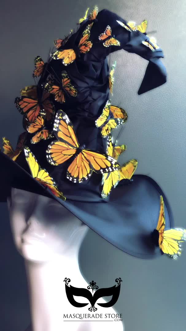 This may contain: a black hat with yellow butterflies on it and a white mannequin's head