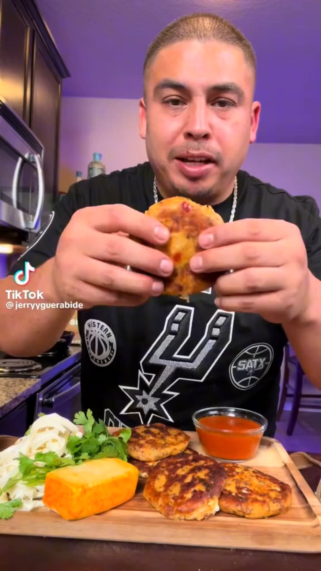 This may contain: a man holding up a piece of food on top of a wooden cutting board in front of his face