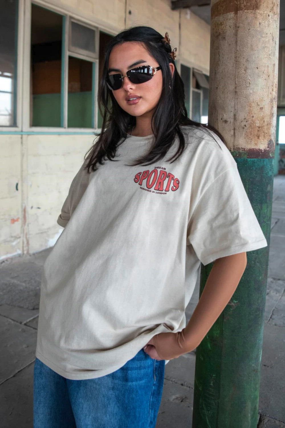 This contains: a woman wearing sunglasses and a t - shirt