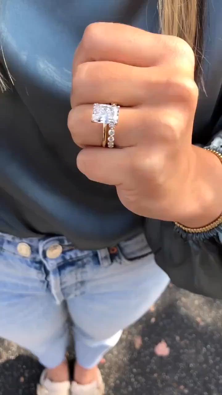 This may contain: a close up of a person's hand with a ring on their finger and wearing jeans