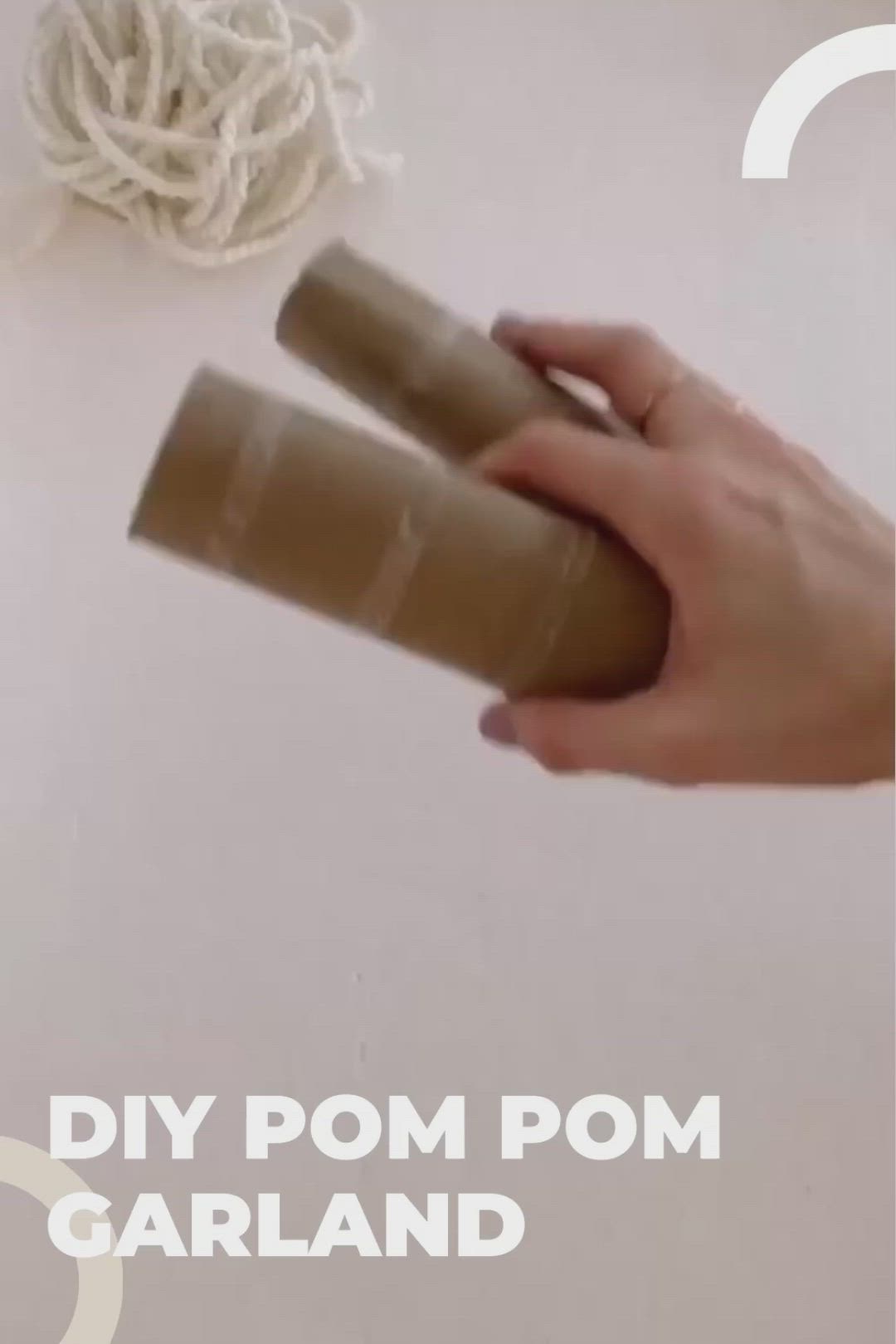 This may contain: someone is making homemade pom - pom garlands out of toilet paper rolls