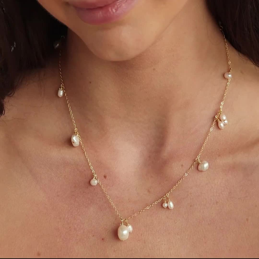 Adorn yourself with timeless elegance wearing our Baroque Pearl Drop Station Necklace. The delicate, minimalist design and lustrous baroque pearls evoke a sense of romance and charm, making it the perfect accessory for brides or wedding guests. Embrace the ethereal beauty and create unforgettable memories with this enchanting necklace ♡ Material: High Quality Solid 925 Sterling Silver Finish: Sterling Silver ∙ 18K Gold Featuring a Baroque Pearl Drop Station Necklace with ~4mm and ~9.5mm beads, w