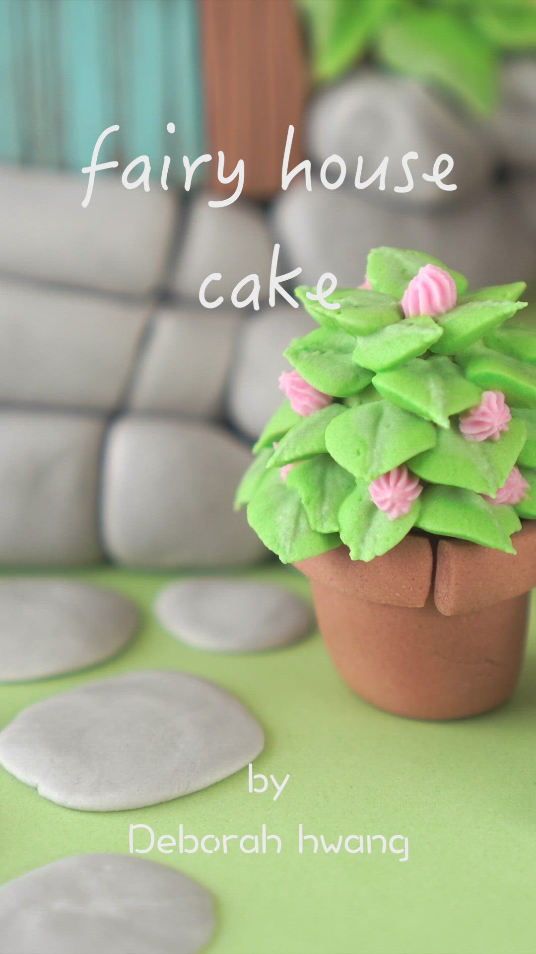 This may contain: a small potted plant sitting on top of a green table next to white rocks