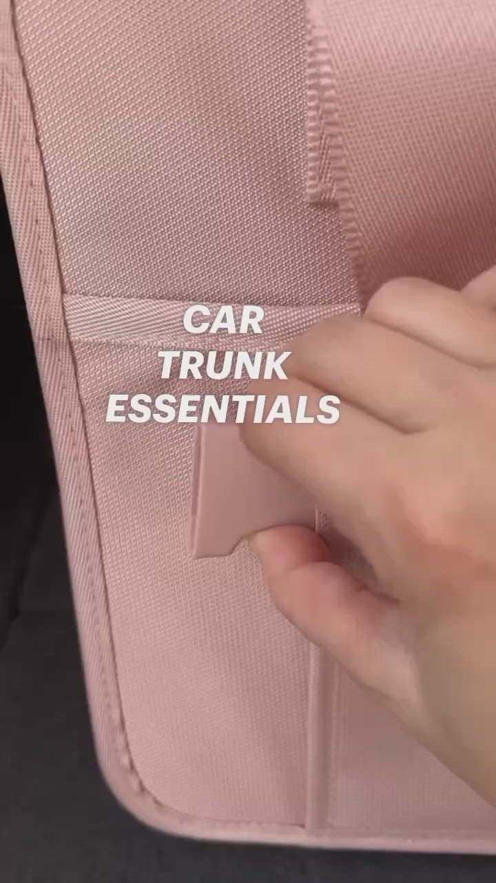 This may contain: someone is holding an empty pink case with the words car trunk essentials