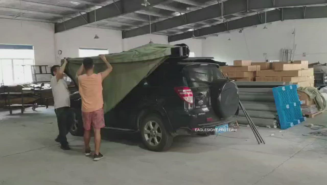 This may contain: two men unloading a truck with a tarp on it's back in a warehouse