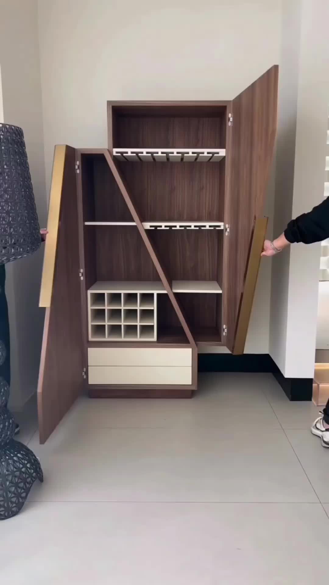 This may contain: a person standing in front of a cabinet with shelves and drawers on the bottom shelf