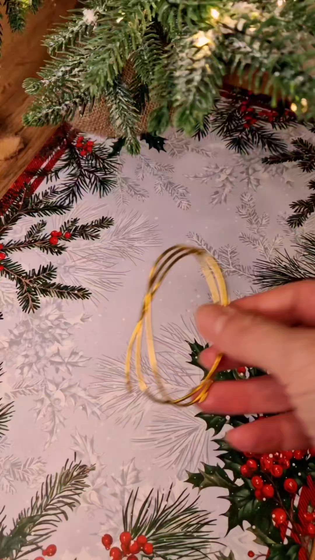 This may contain: someone is making a christmas tree skirt out of wrapping paper and twine with scissors