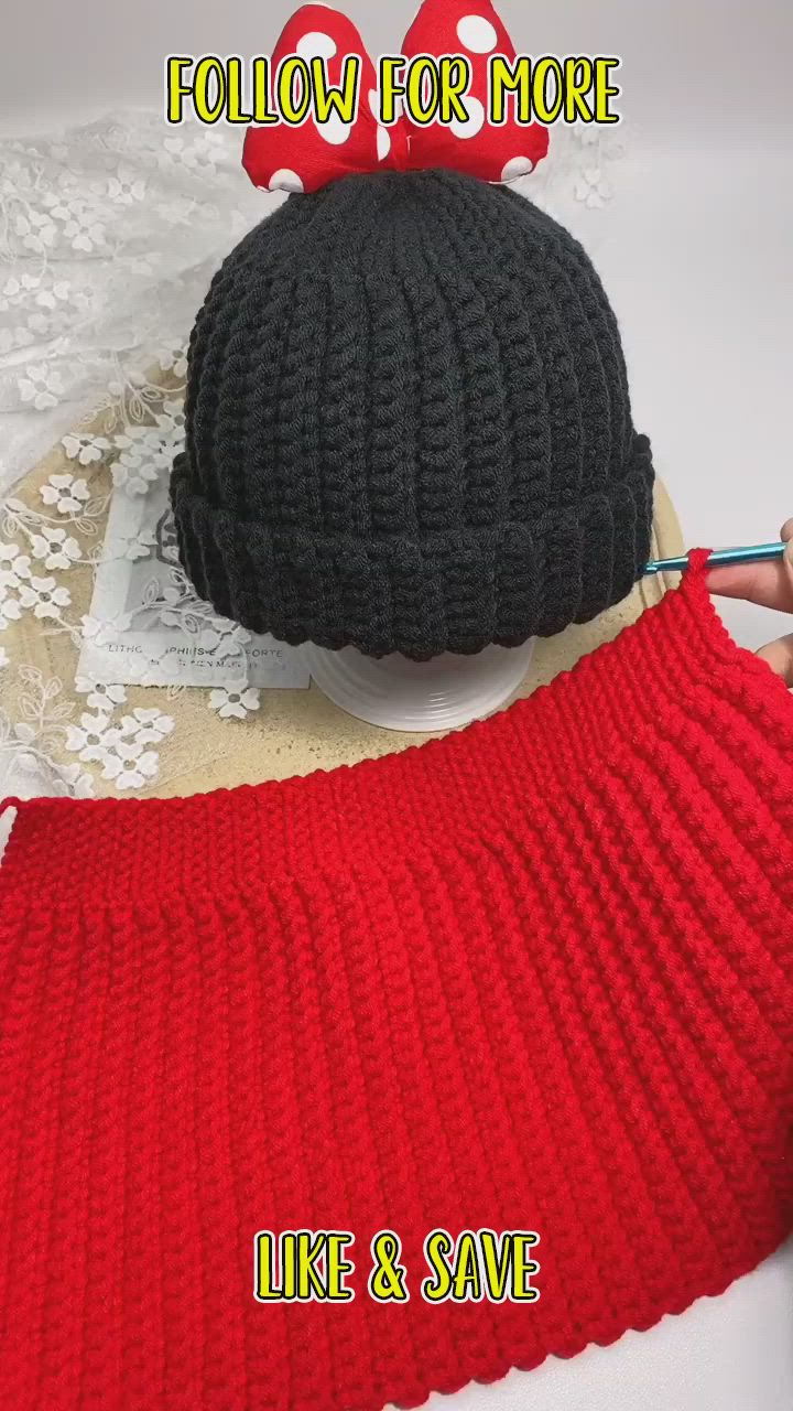 This may contain: there are two knitted hats on top of each other, one is black and the other is red