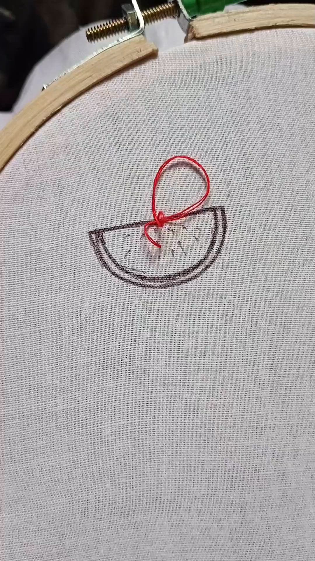 This may contain: a close up of a piece of cloth with a red ribbon on it