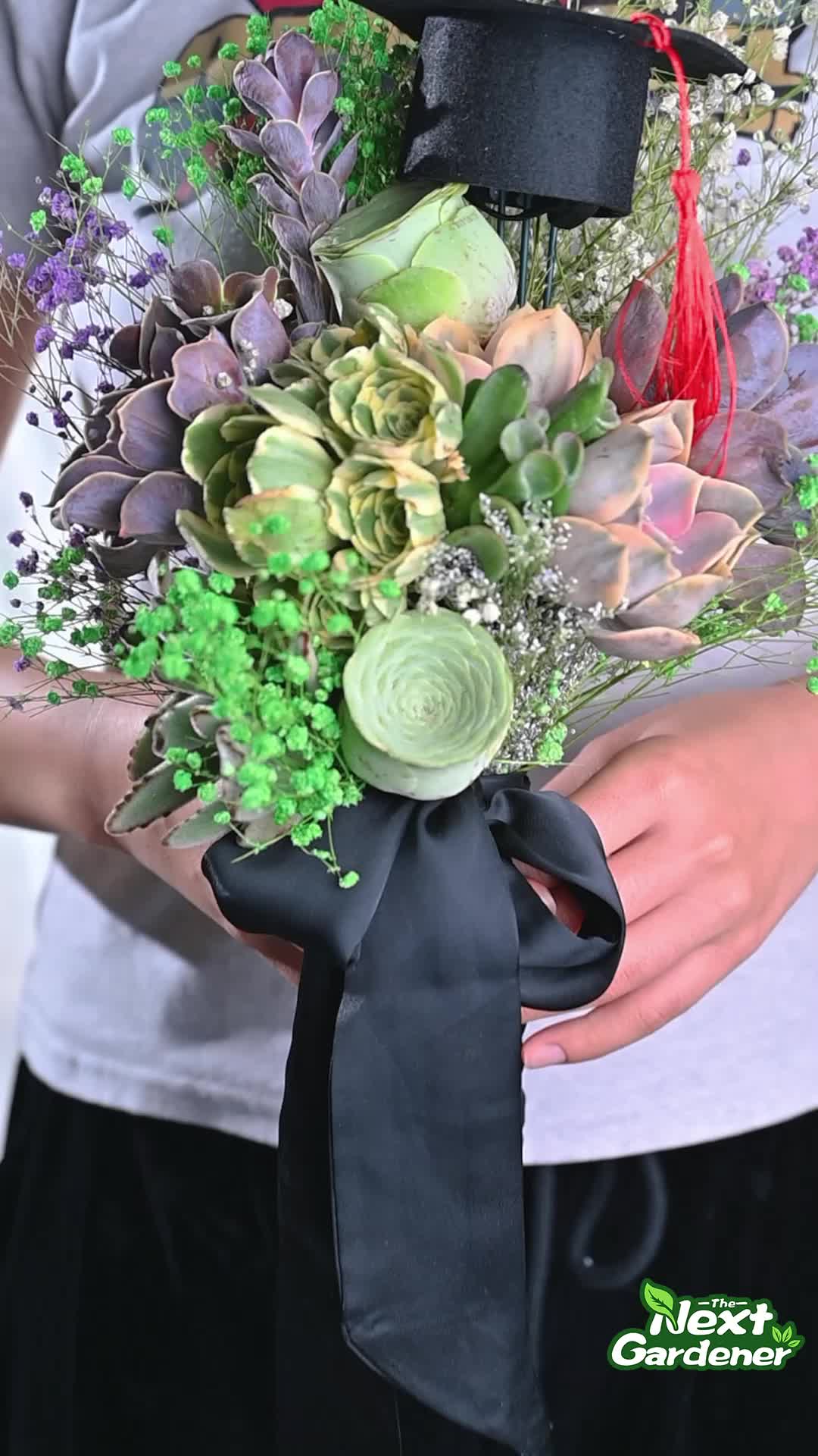 This may contain: the graduation bouquet is being held in front of a graduate's cap and diploma