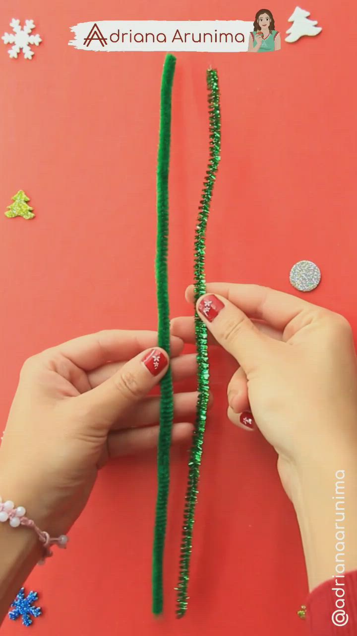 This may contain: two hands are holding green beads on a red surface