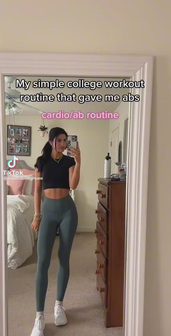 This may contain: a woman taking a selfie in front of a mirror with the caption, my simple college workout routine that gave me abs