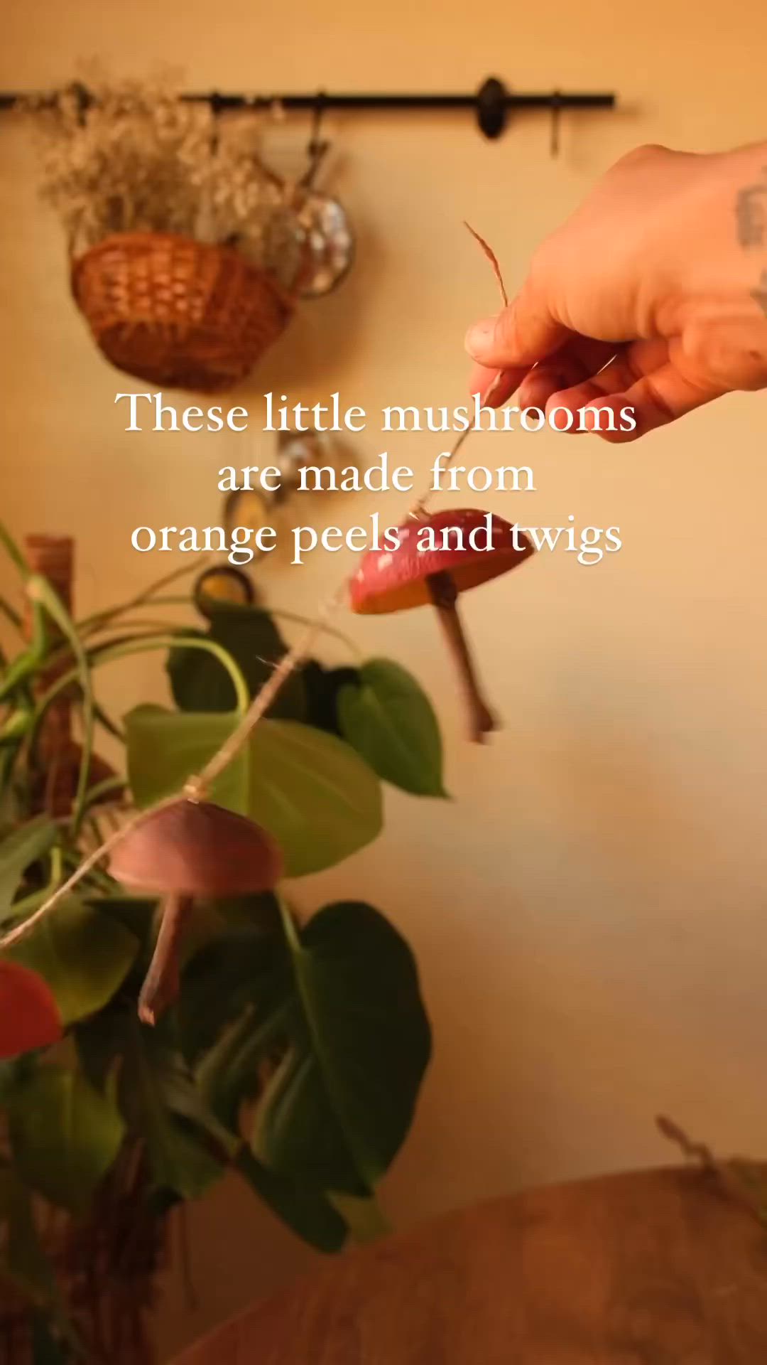 This may contain: a person is holding something in their hand with a quote on it that reads, these little mushrooms are made from orange peels and twigs