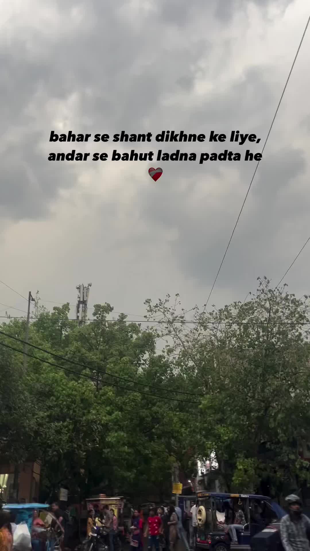 This may contain: people are walking on the street with kites flying in the sky above them and an advertisement that reads bahar so that didn't