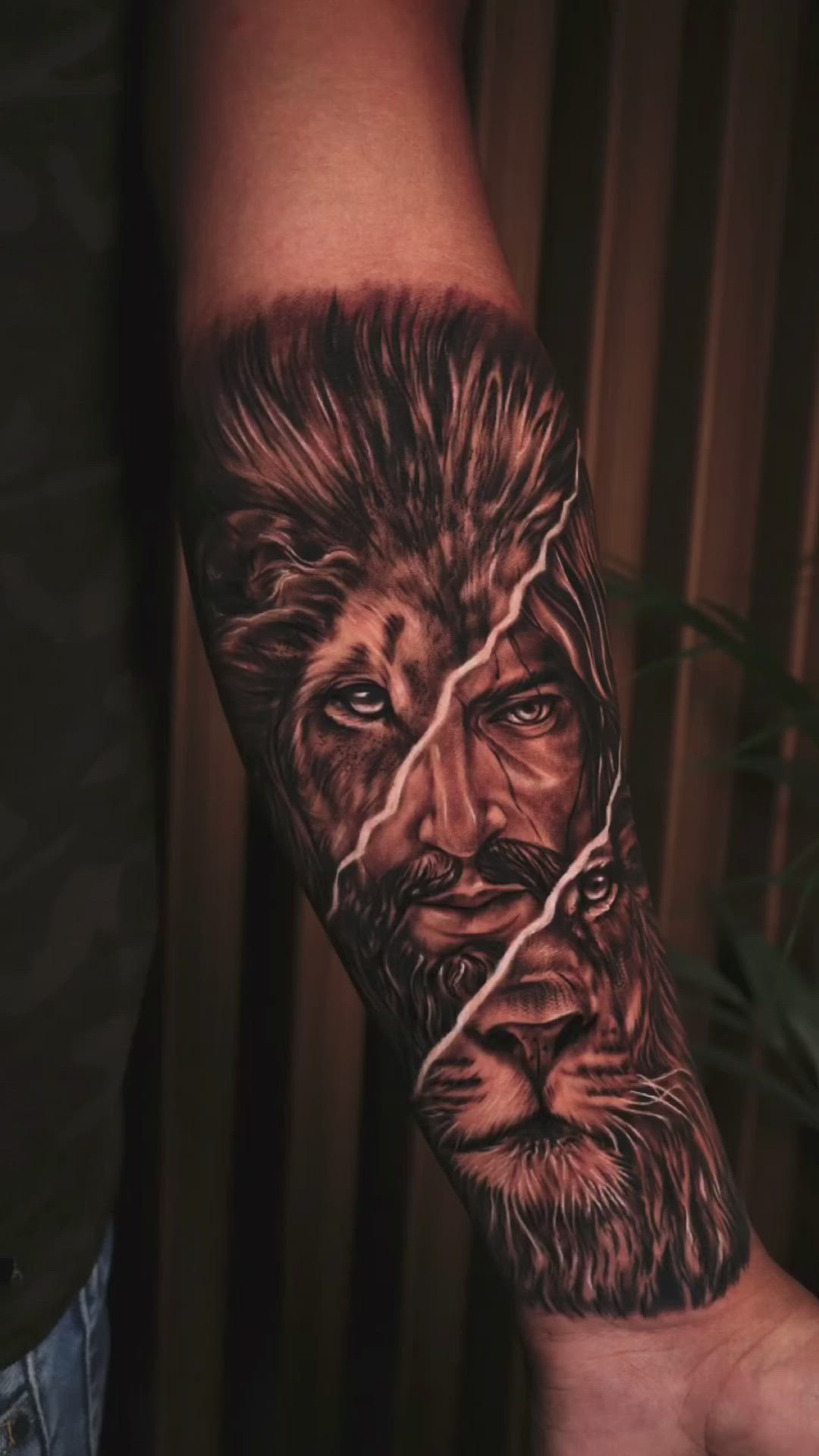 This may contain: a man's arm with a lion tattoo on it and his face painted in black ink