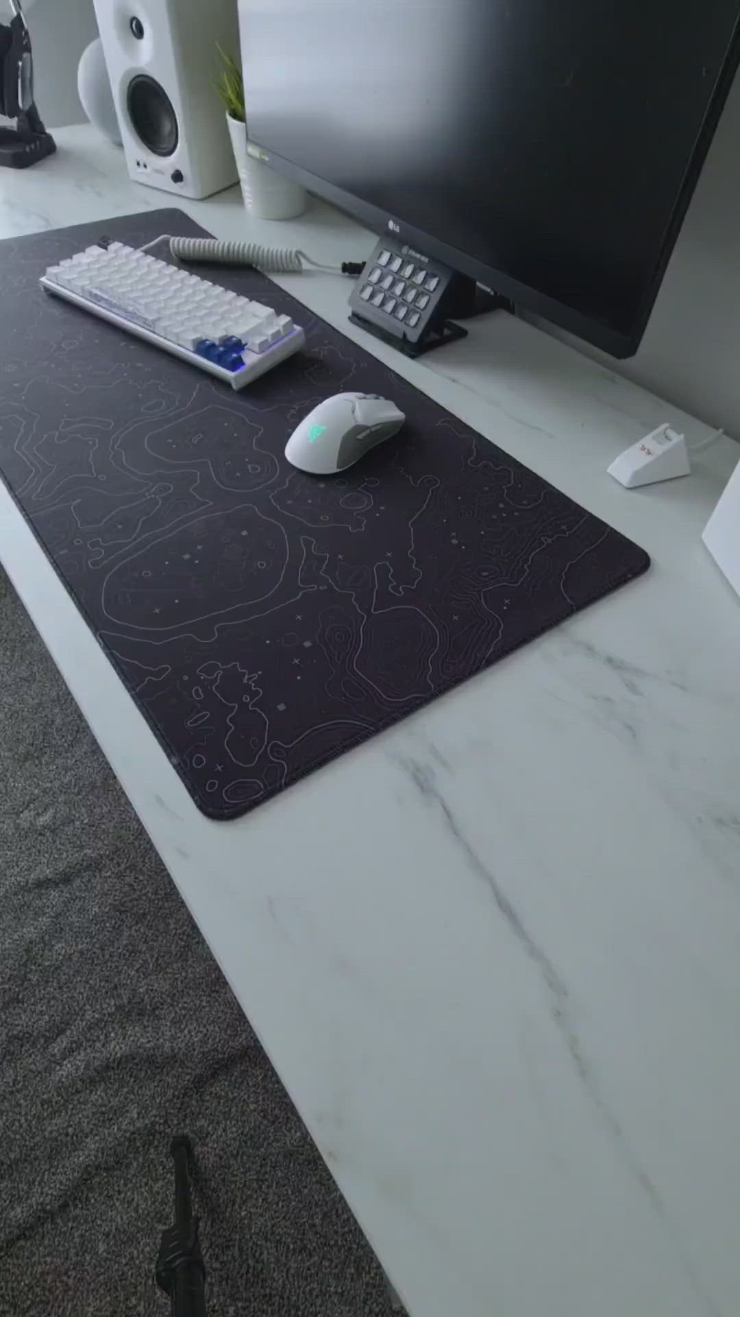 This may contain: a computer desk topped with two monitors next to a keyboard and mouse on top of a white table