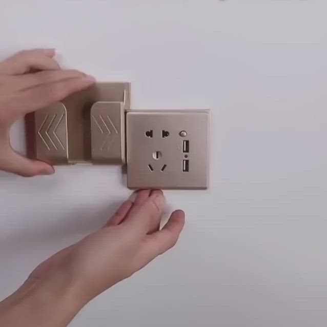 This may contain: two hands are holding an electrical outlet in the shape of a box and plugged into it