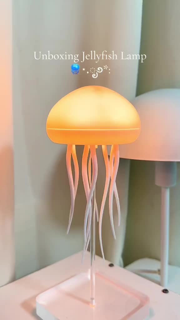 This may contain: a jellyfish lamp sitting on top of a white table