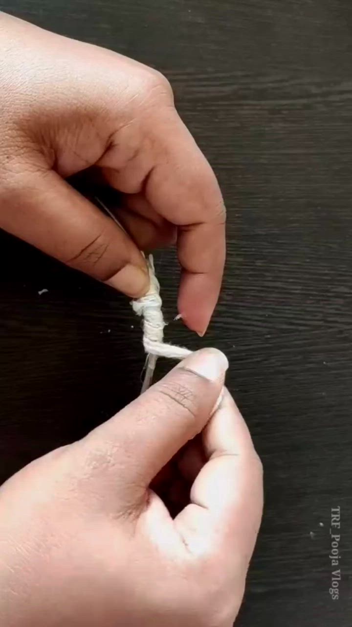 This may contain: someone is peeling the end of a piece of string with their fingers on a table