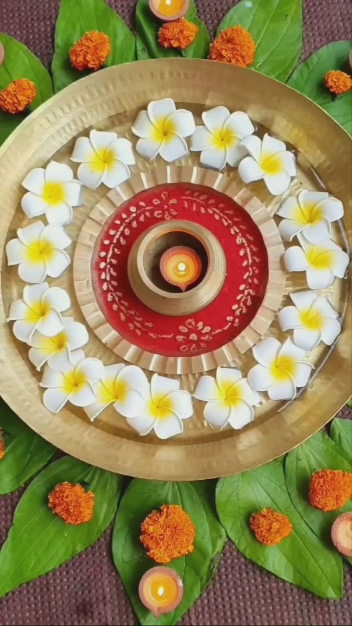 This may contain: an overhead view of a decorative plate with flowers and candles on it, surrounded by leaves