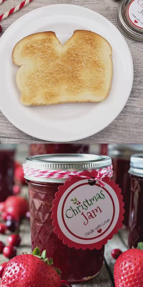 This may contain: a piece of toast on top of a jar of jam with strawberries around it