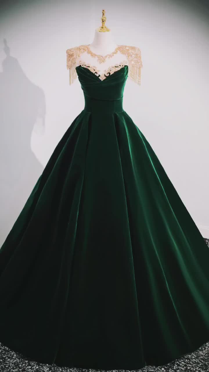 This contains: Simple Dark Green Long Velvet Formal Dress with Gold Beading Shoulders