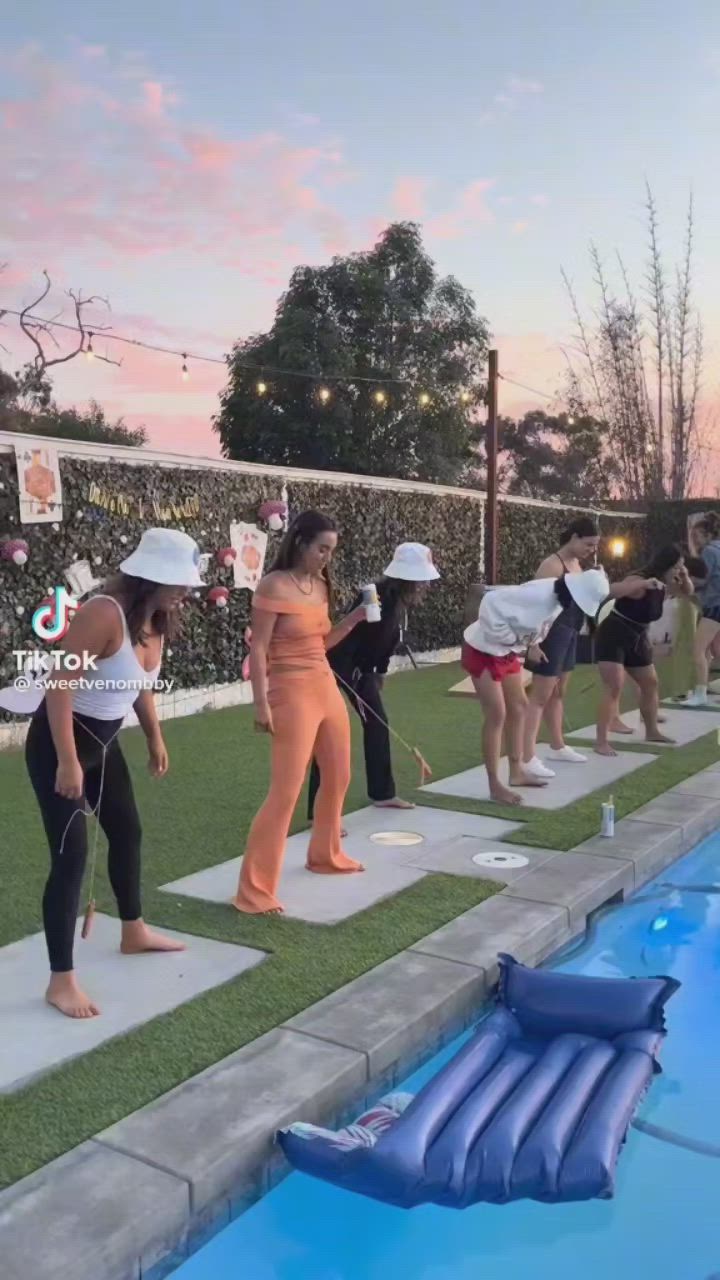 This may contain: people doing yoga in front of a swimming pool