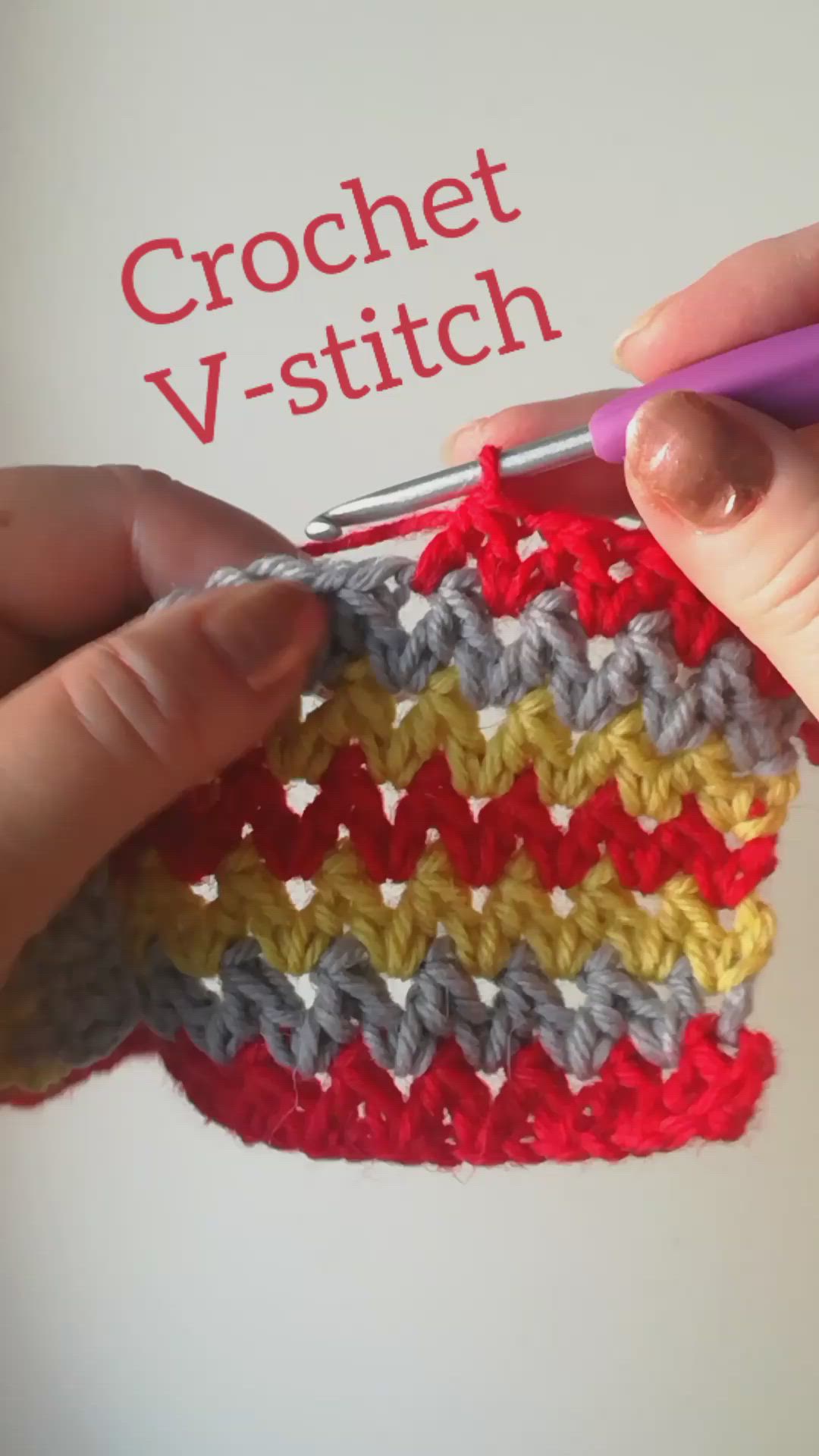 This may contain: the crochet v - stitch pattern is being worked on by someone holding a pair of scissors