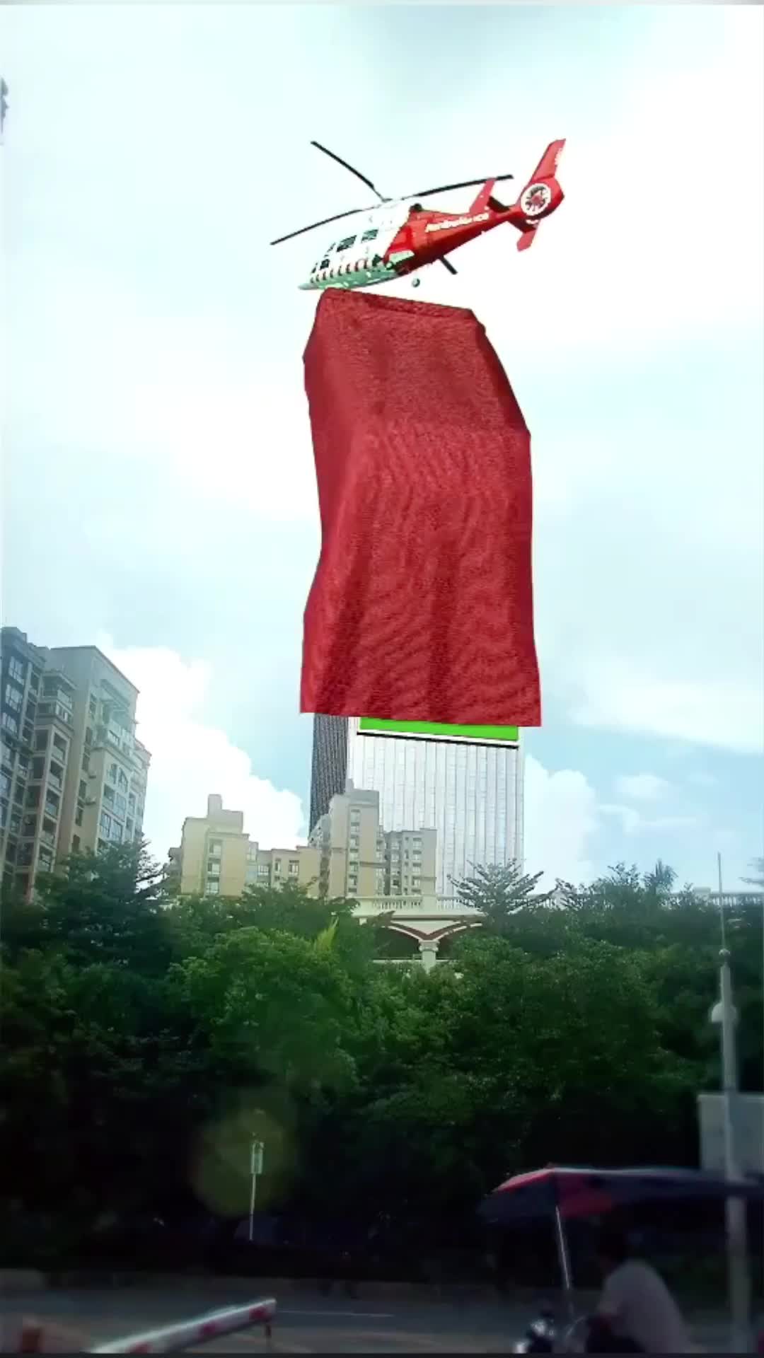 This may contain: a red helicopter flying over a tall building