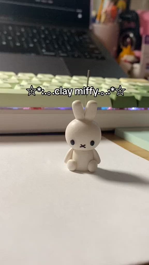 This may contain: a small white rabbit figurine sitting on top of a desk