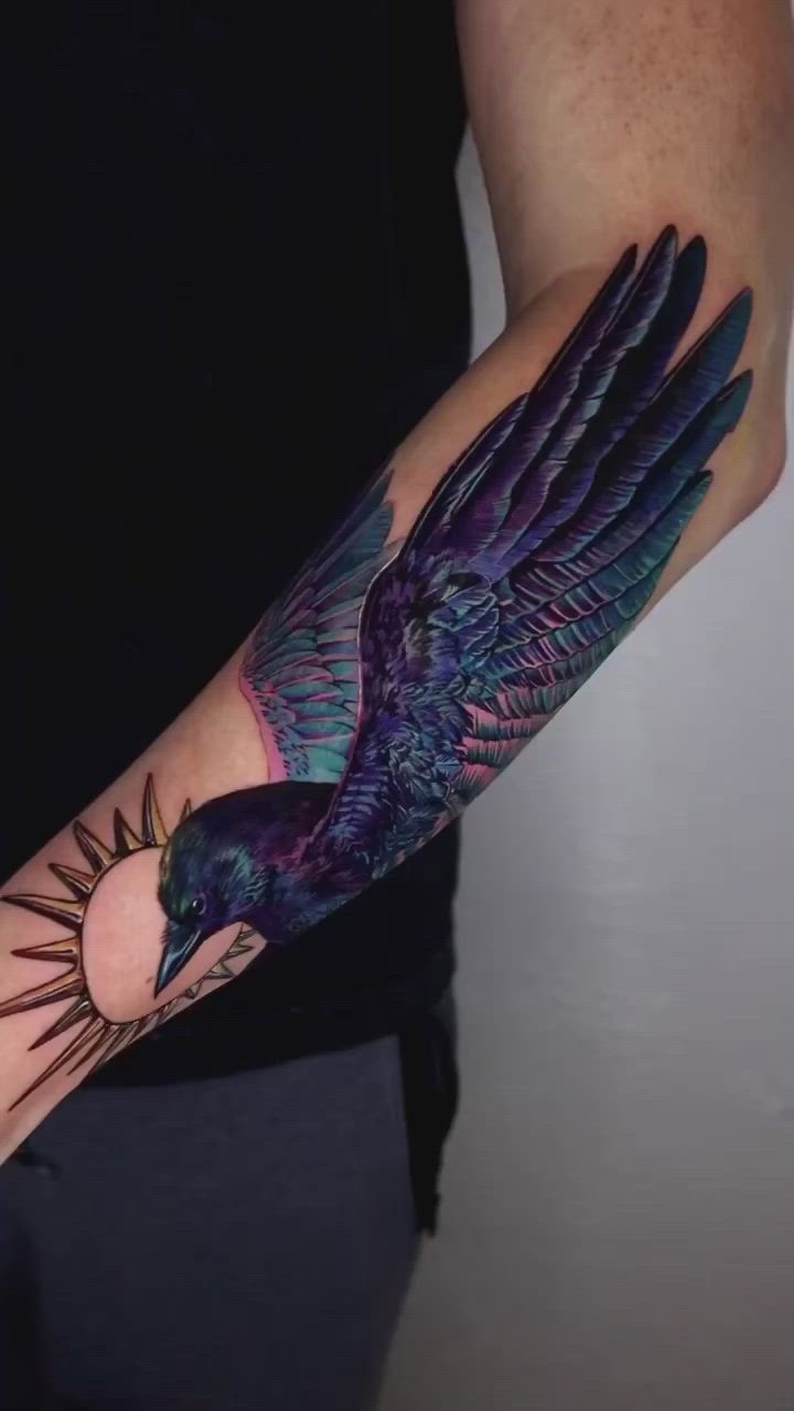 This may contain: a man's arm with a bird tattoo on it