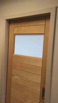 This may contain: a wooden door in a room with white walls