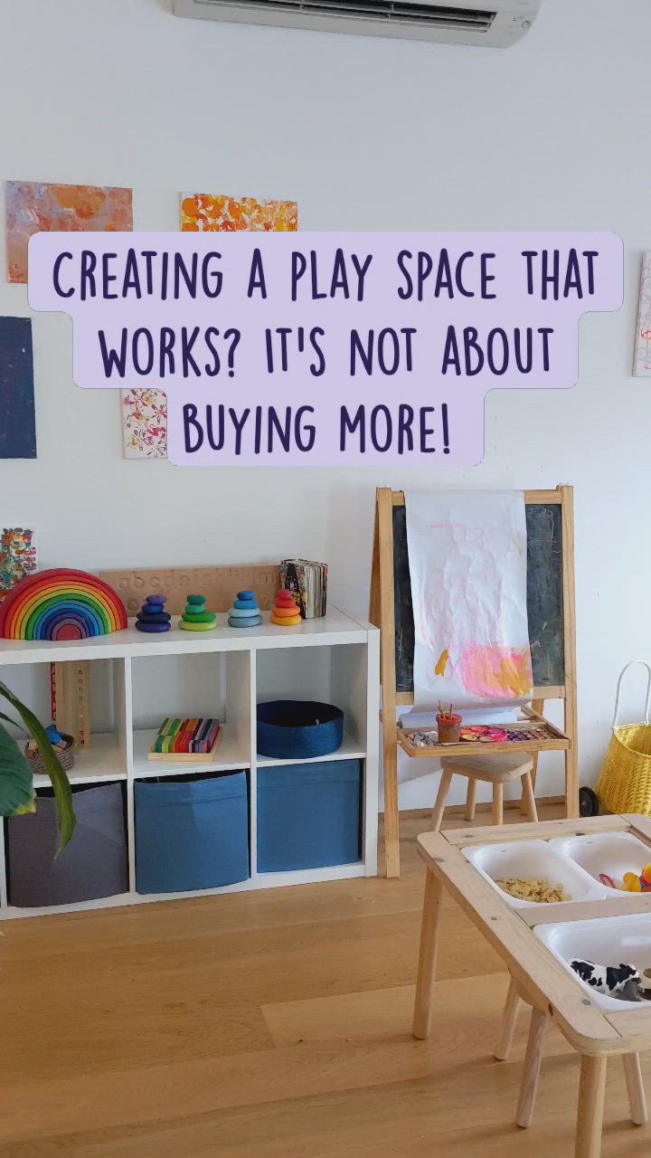 This may contain: a child's play room with toys and artwork on the wall, including an easel