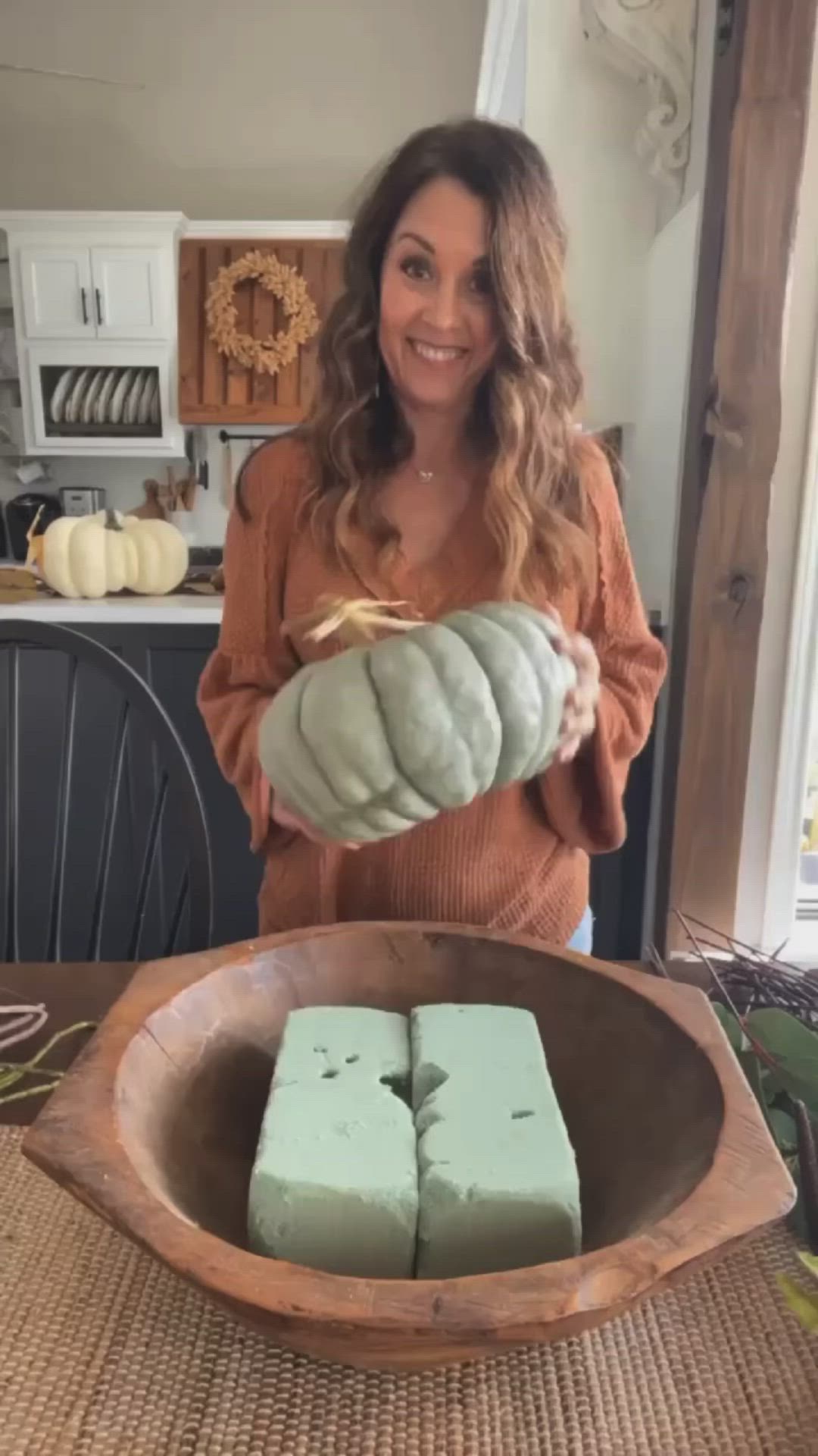 This may contain: a white pumpkin sitting on top of a wooden table