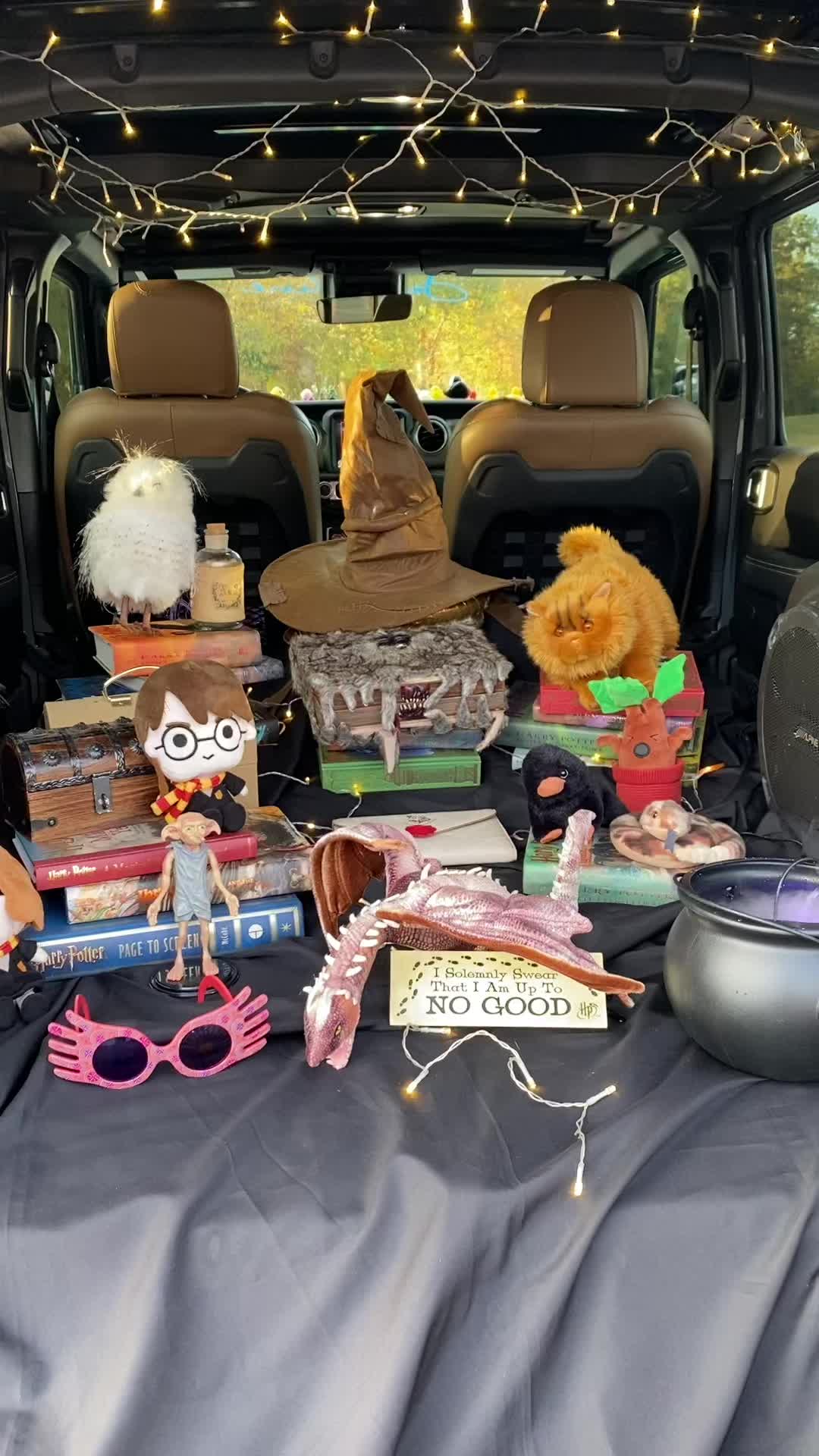 This may contain: the back end of a car filled with stuffed animals and other items, including toys