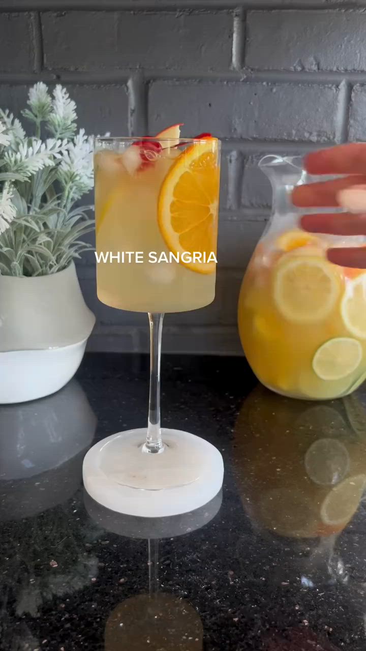 This contains: Invigorating White Sangria video showcasing a beautiful infusion of flavors and colorful fruit garnish. #WhiteSangria #SummerSips