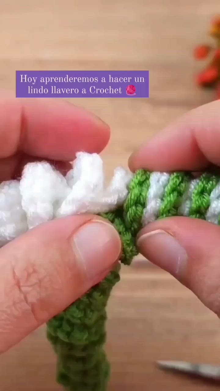 This may contain: someone is crocheting the end of a piece of yarn with their hands and fingers