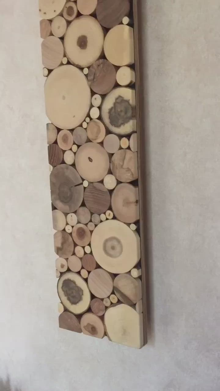 This may contain: a piece of wood that has been cut into smaller pieces and is hanging on the wall